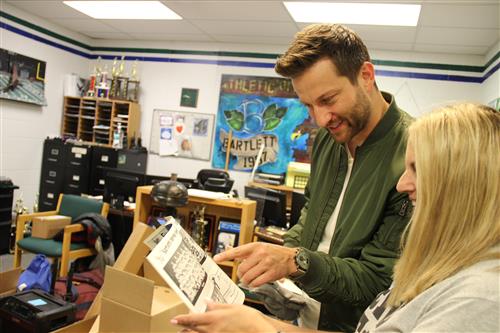 Chris Bukowski looks at an old yearbook at his alma mater, Bartlett High School 